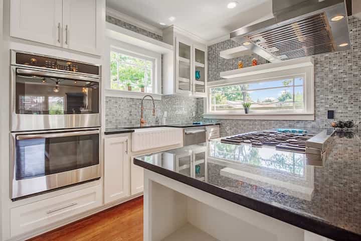 An image of a modern kitchen with sleek appliances, featuring a gas stove, refrigerator, and built-in microwave in Voorhees Township
